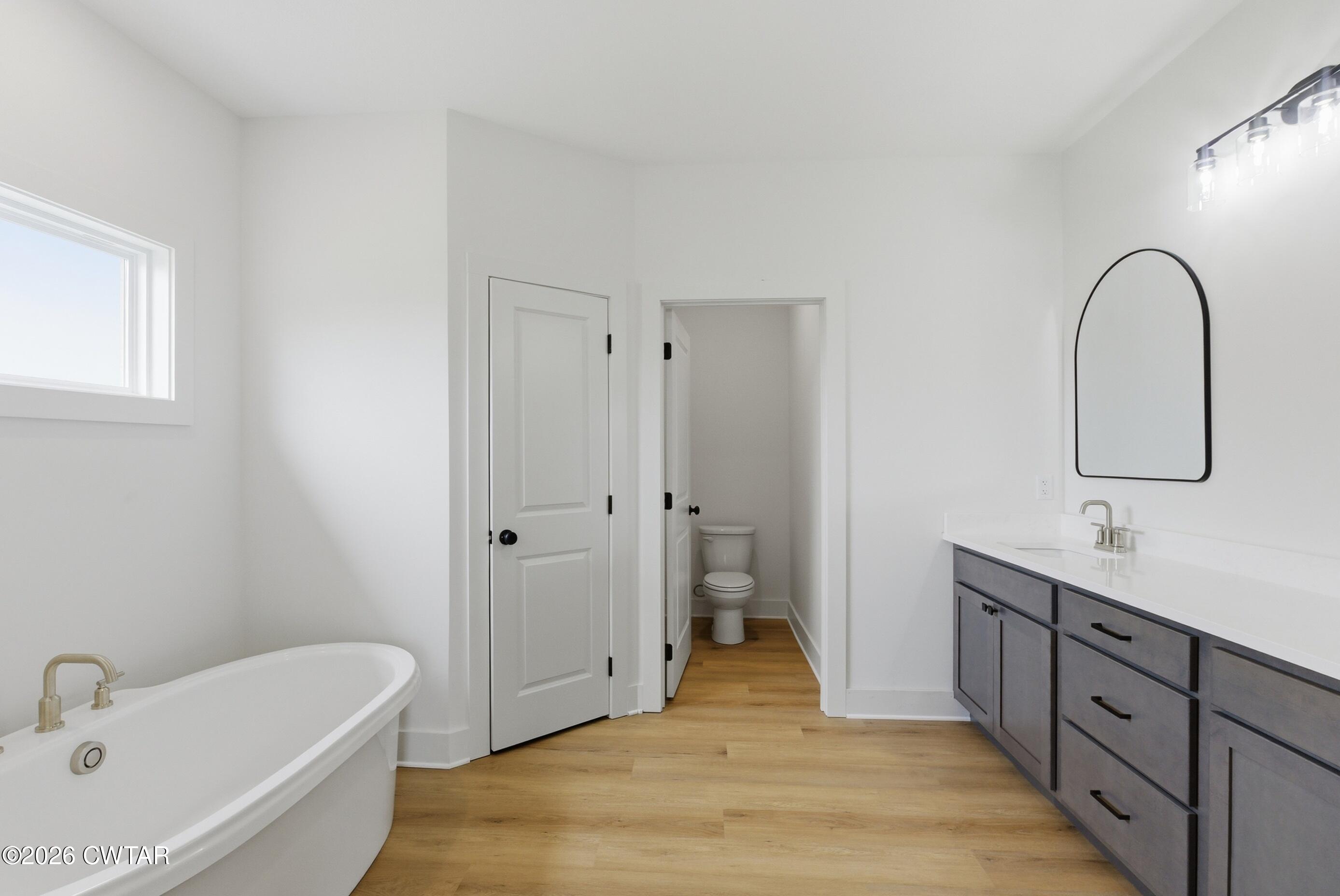 179 Daybreak Loop Medina, TN 38355 - Photo 19 of 32 a spacious bathroom with a tub sink and mirror