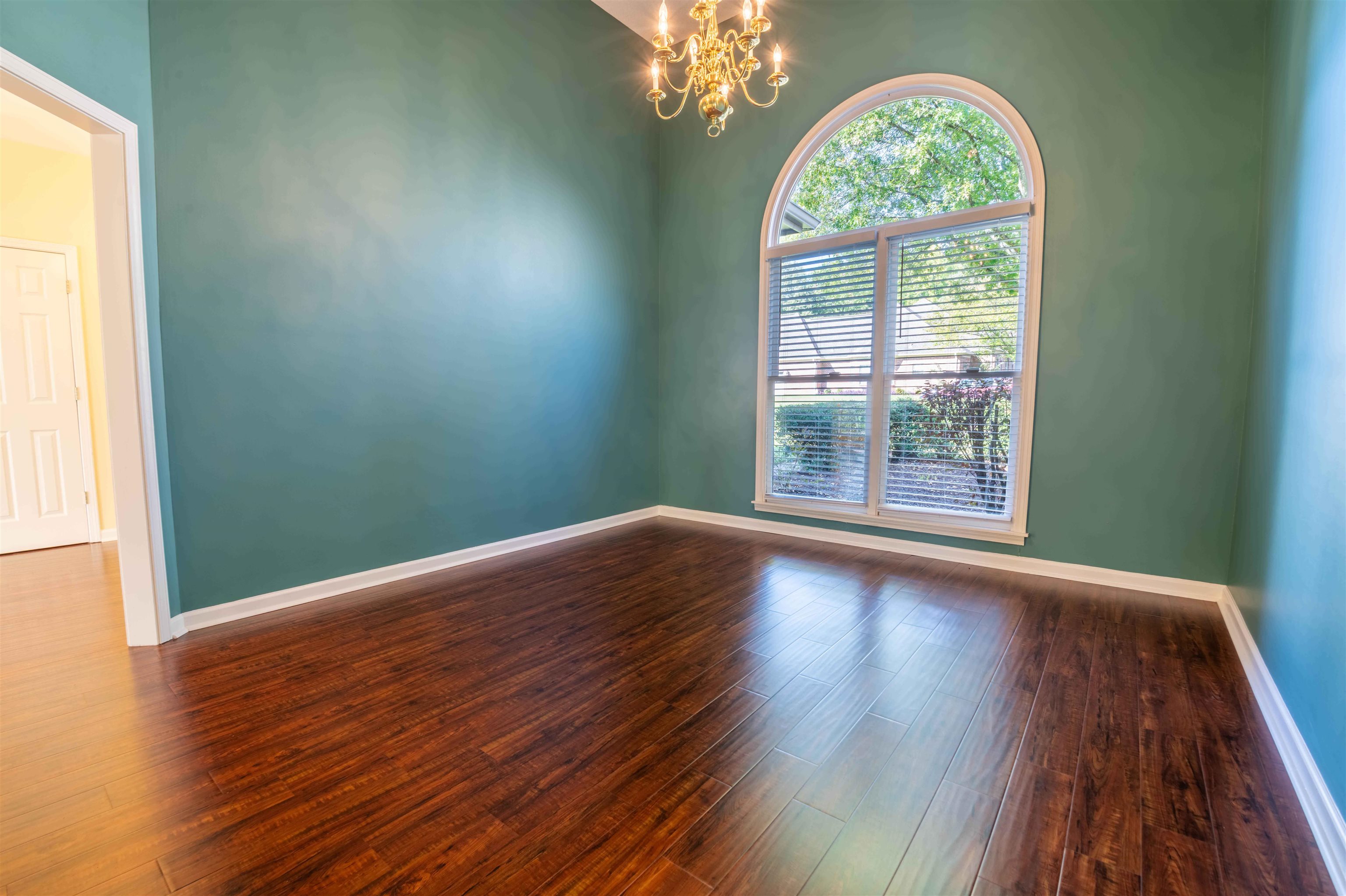 4170 Calla Drive Bartlett, TN 38135 - Photo 13 of 40 an empty room with wooden floor and windows
