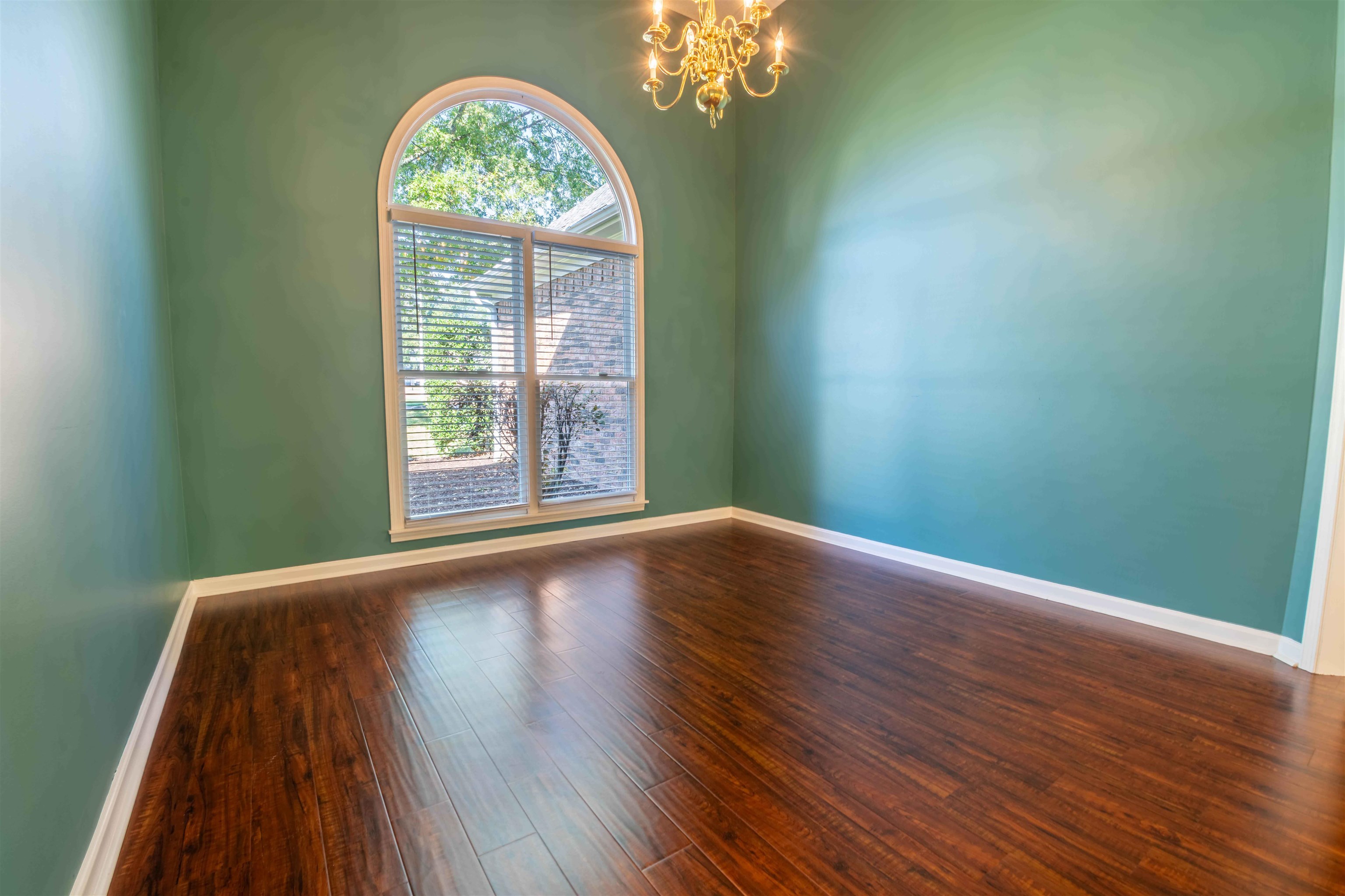 4170 Calla Drive Bartlett, TN 38135 - Photo 14 of 40 a view of an empty room with wooden floor and a window