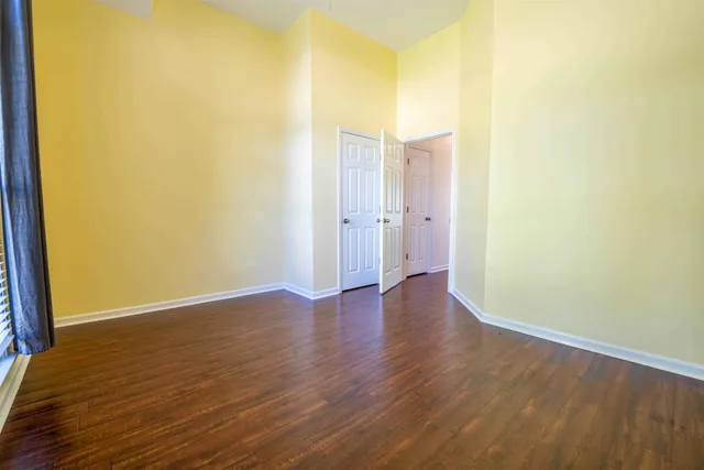 a view of a room with wooden floor