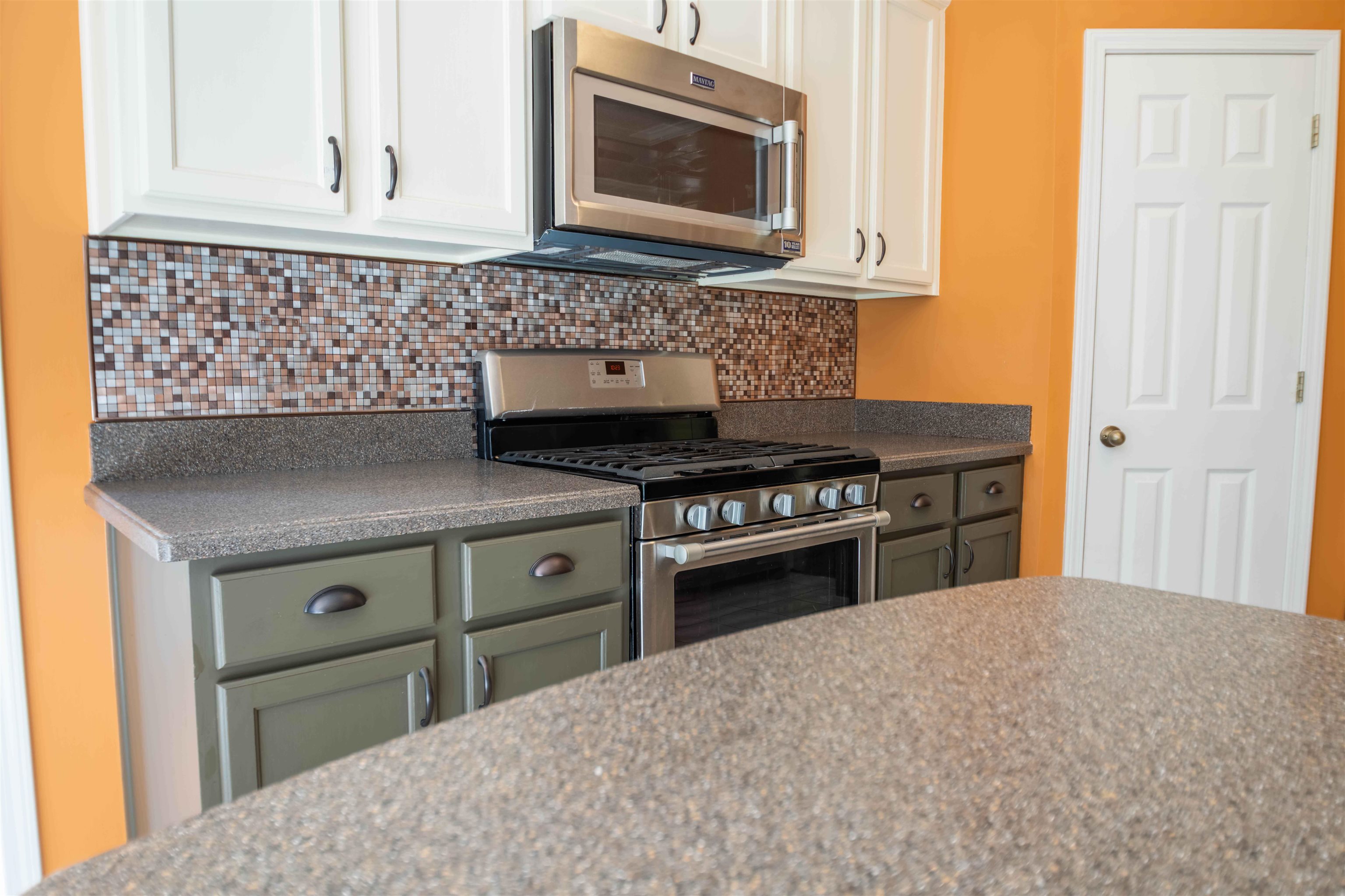 4170 Calla Drive Bartlett, TN 38135 - Photo 5 of 40 a kitchen with granite countertop a stove and a microwave