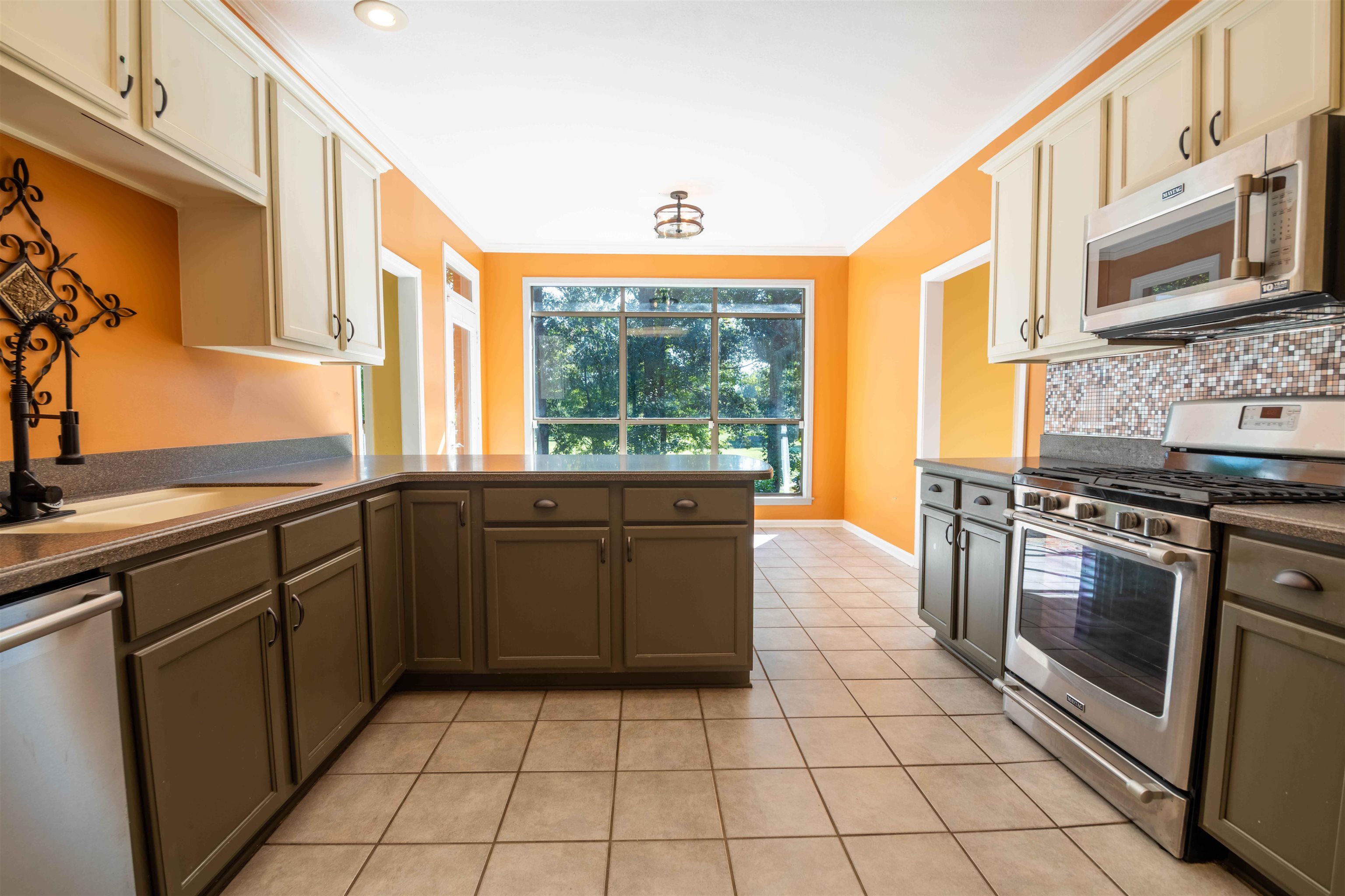 4170 Calla Drive Bartlett, TN 38135 - Photo 6 of 40 a kitchen with stainless steel appliances granite countertop a stove a sink and a microwave