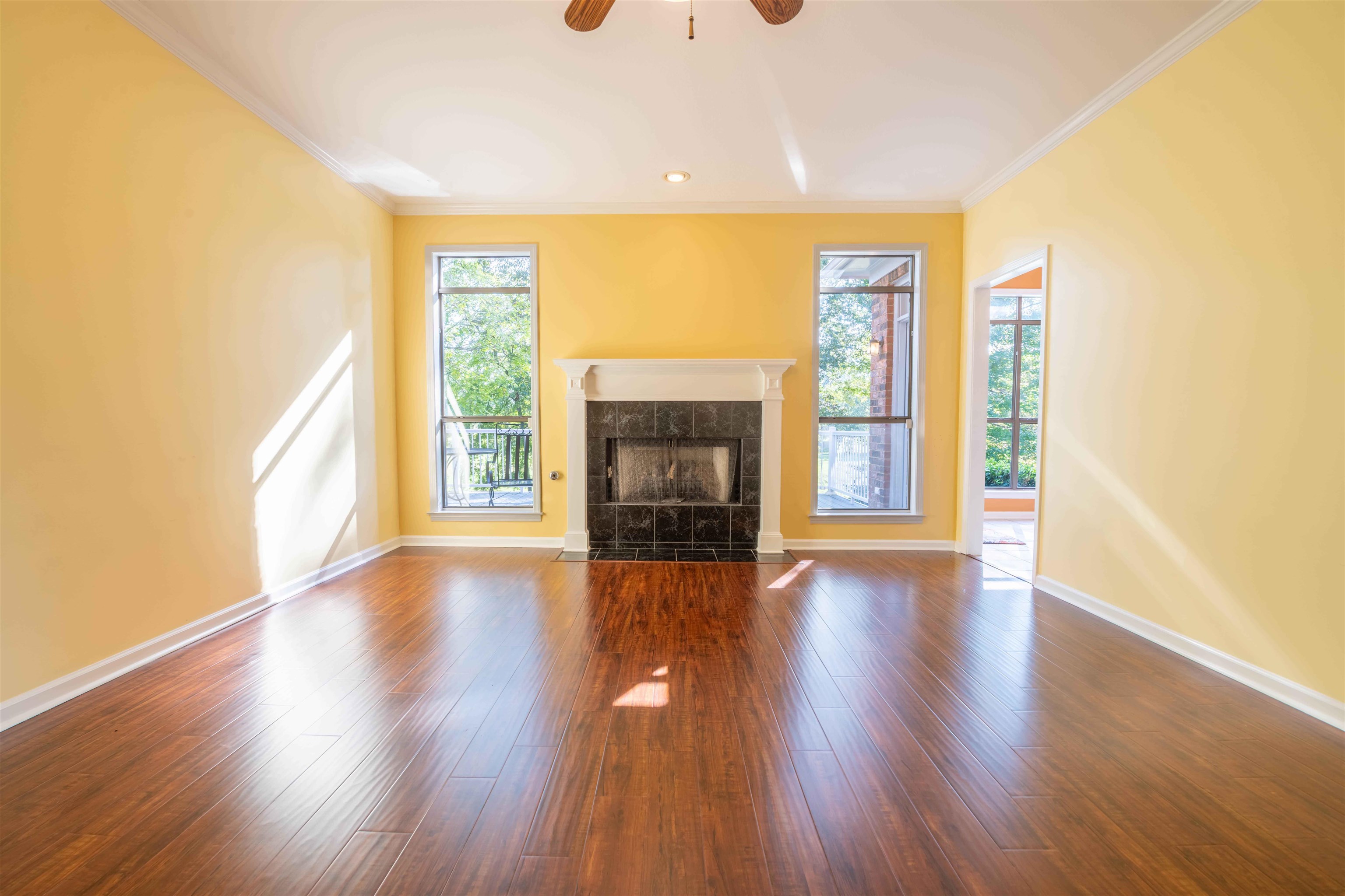 4170 Calla Drive Bartlett, TN 38135 - Photo 9 of 40 a view of an empty room with wooden floor fireplace and a window
