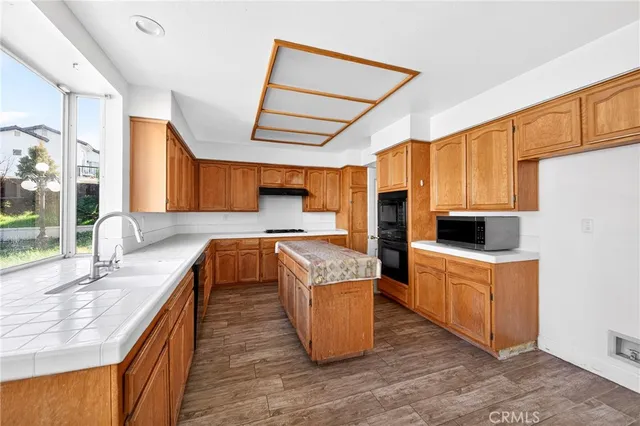 a kitchen with wooden cabinets and a sink