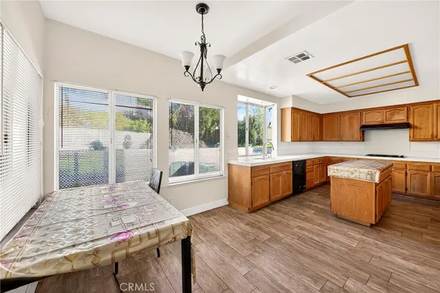 a large kitchen with kitchen island a large island in it