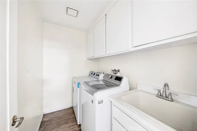 a utility room with sink dryer and washer