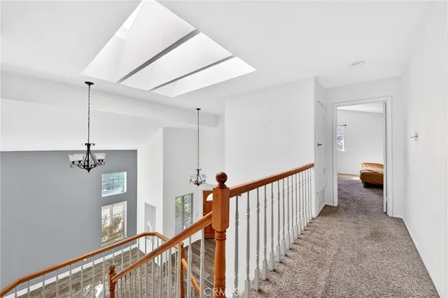 a view of a hallway with a livingroom and stairs
