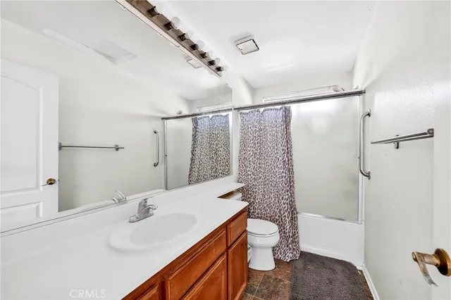 a bathroom with a sink and mirror with toilet