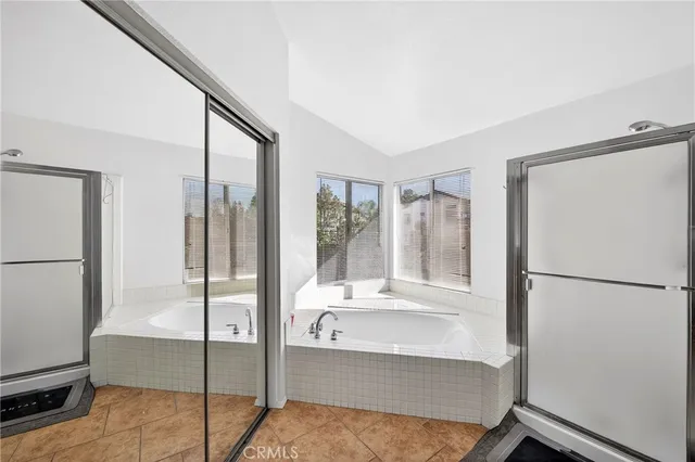 a bathroom with a tub shower and sink