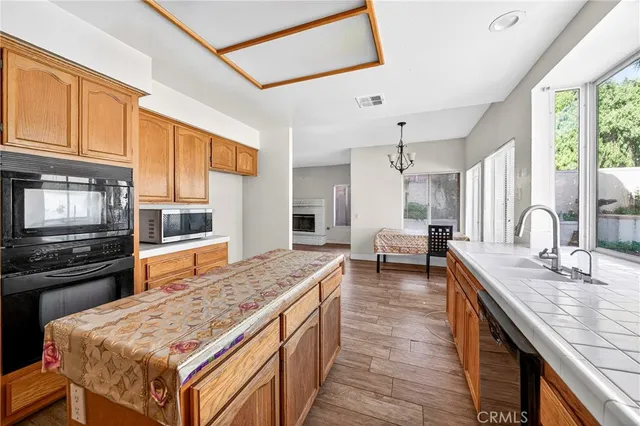 a kitchen with stainless steel appliances granite countertop a stove refrigerator and cabinets