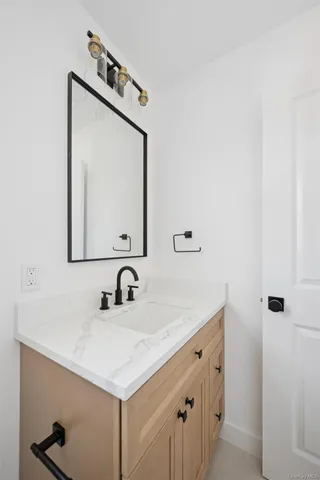 a bathroom with a sink vanity and a mirror