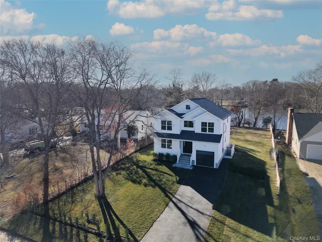 a aerial view of a house next to a big yard