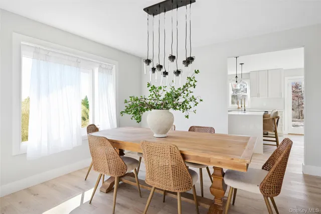 a dining room with furniture and wooden floor