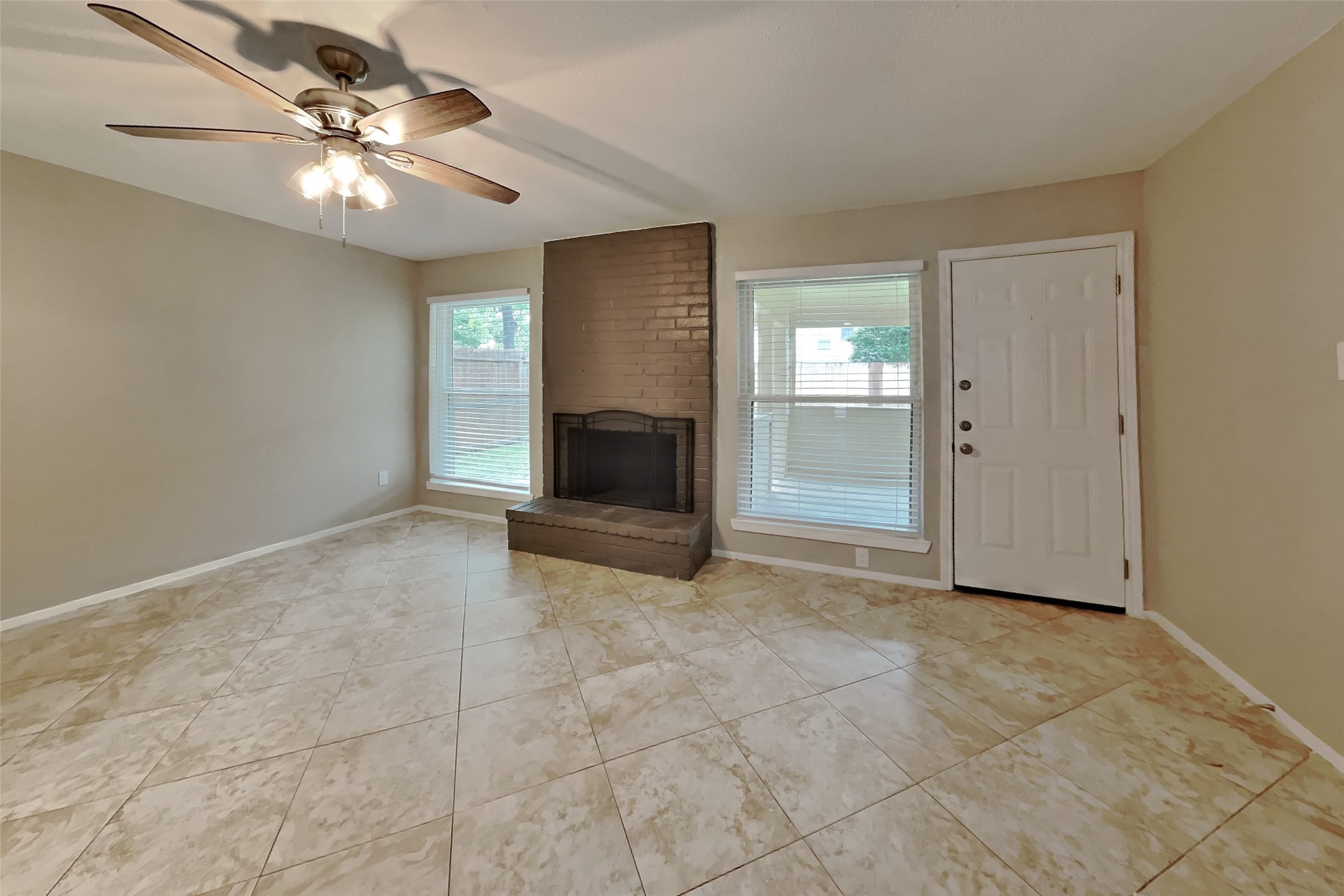 10015 Rippling Fields Drive Houston, TX 77064 - Photo 3 of 24 a view of an empty room with a fireplace