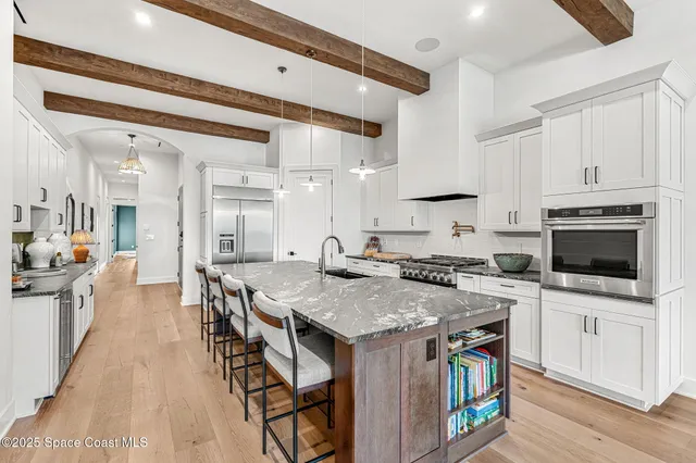 a living room with furniture a fireplace and a large window
