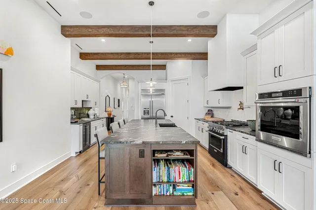 a living room with furniture a rug and a chandelier