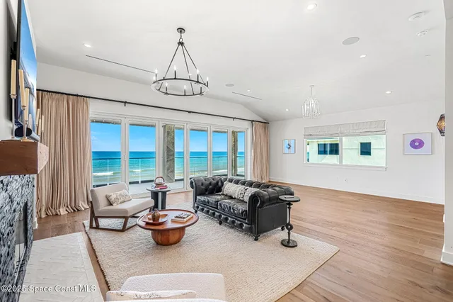 a living room with furniture and a floor to ceiling window