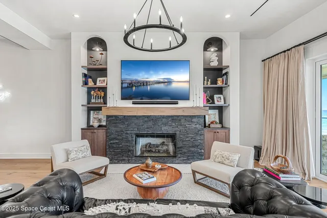 a spacious bedroom with a bed a flat screen tv and a large window