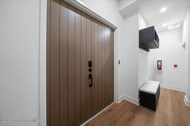 a kitchen with stainless steel appliances granite countertop a refrigerator a sink and wooden floors