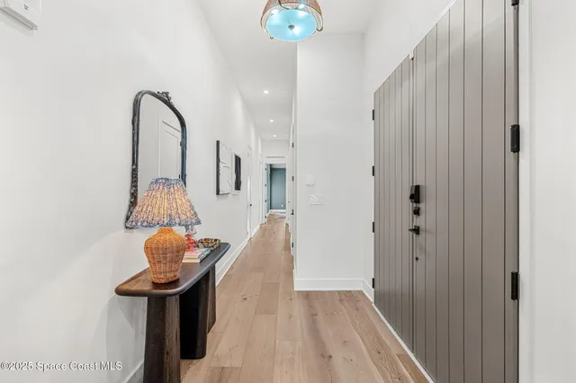 a view of a room with wooden floor table and chairs