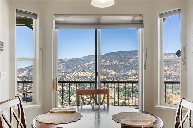 a kitchen with stainless steel appliances granite countertop a refrigerator a sink a stove a microwave and wooden cabinets