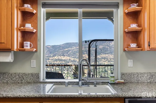 a kitchen with stainless steel appliances granite countertop a refrigerator a stove and a wooden floors