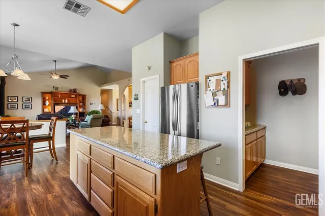 a kitchen with stainless steel appliances granite countertop a refrigerator stove microwave and sink