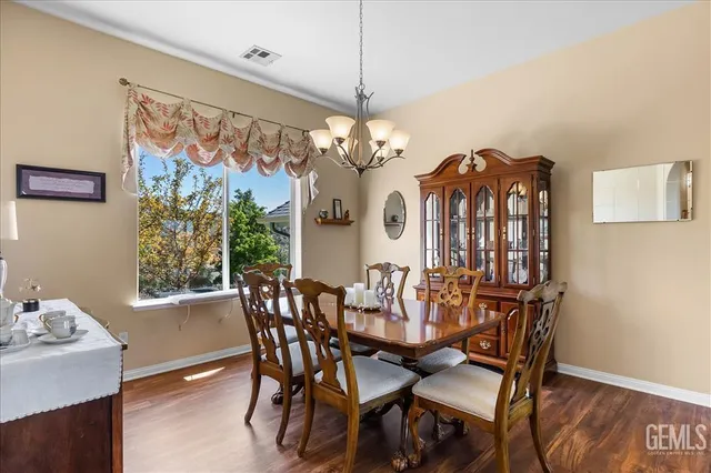 a view of a dining room with furniture wooden floor and chandelier