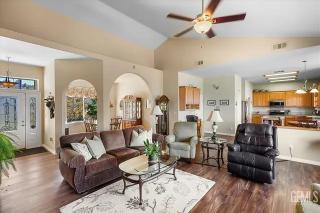a living room with furniture fireplace and a large window