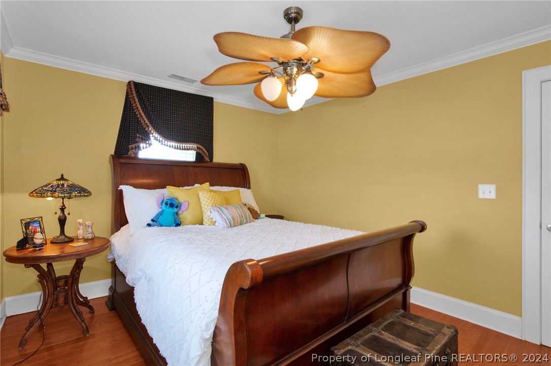 7311 Maxwell Road Stedman, NC 28391 - Photo 21 of 37 a bedroom with a bed and a chandelier