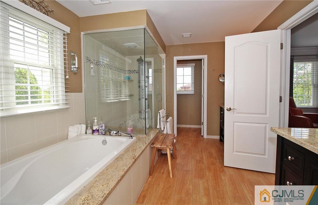 5 Timber Road Edison, NJ 08820 - Photo 18 of 24 a bathroom with a tub sink and mirror