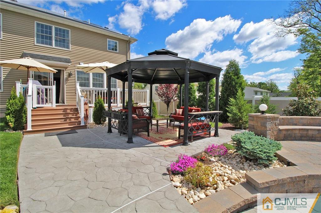 5 Timber Road Edison, NJ 08820 - Photo 24 of 24 a view of a patio with table and chairs under an umbrella