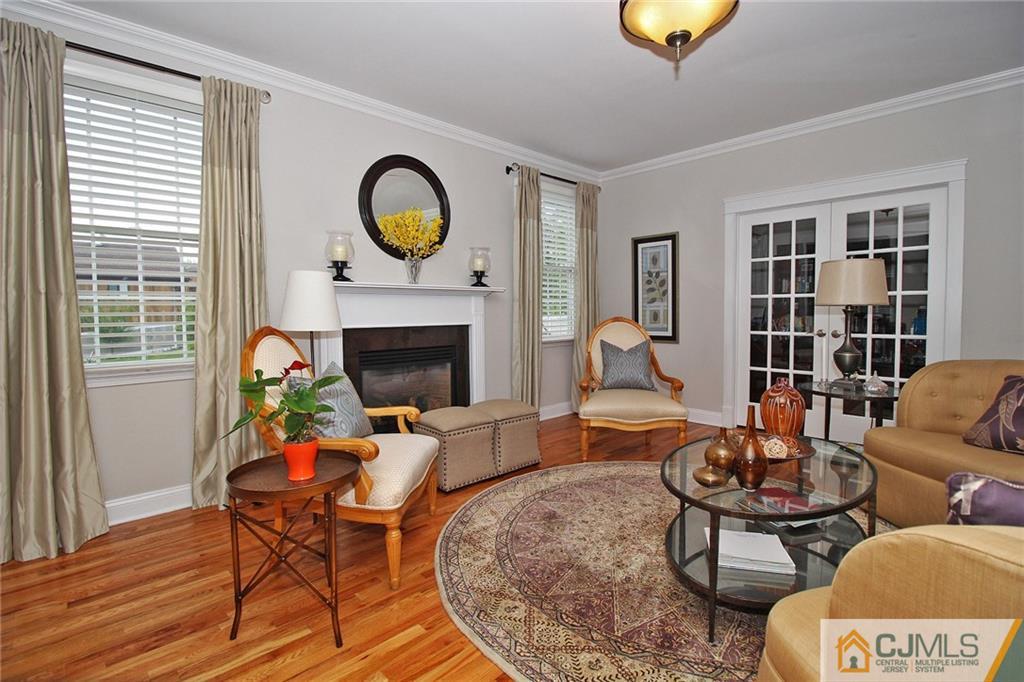 5 Timber Road Edison, NJ 08820 - Photo 8 of 24 a living room with furniture a rug and a fireplace