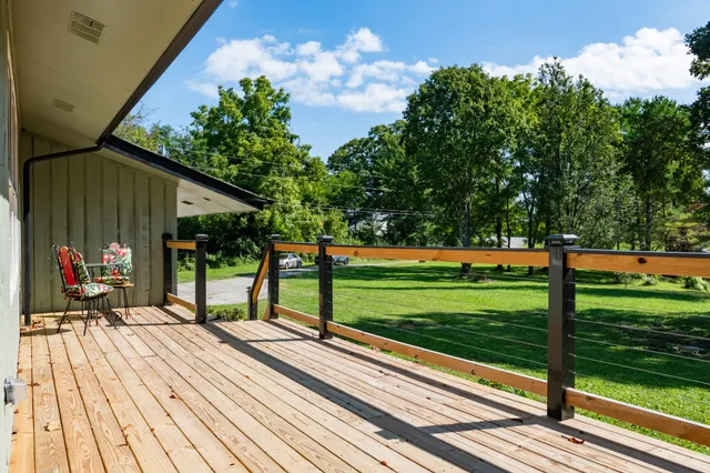 a view of hallway with furniture and wooden floor