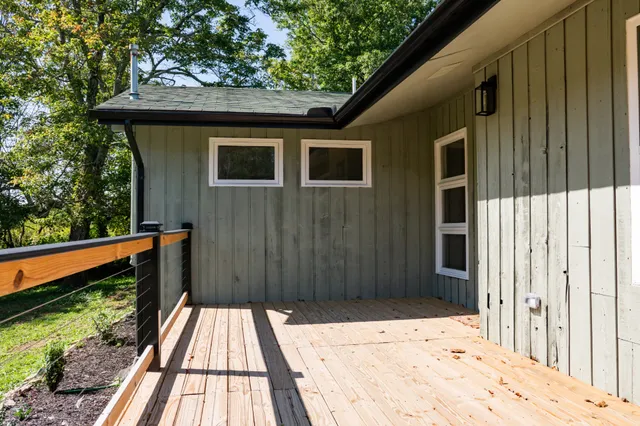 a kitchen with stainless steel appliances granite countertop a refrigerator a stove and a wooden floors