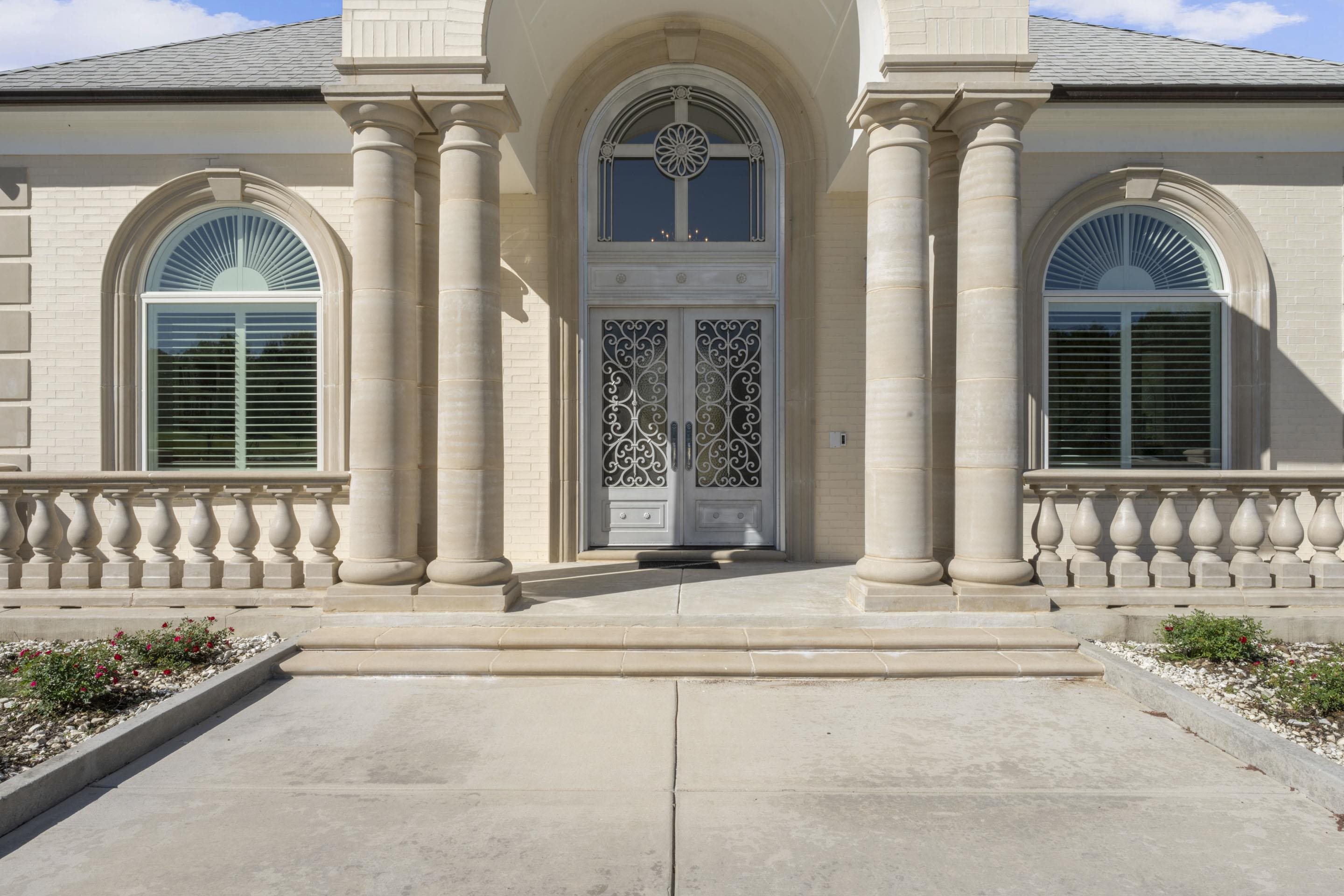 881 Bray Station Road Collierville, TN 38017 - Photo 27 of 40 View of exterior entry with brick siding, a shingled roof, and a porch