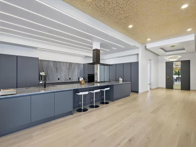 a living room with patio furniture and a large window