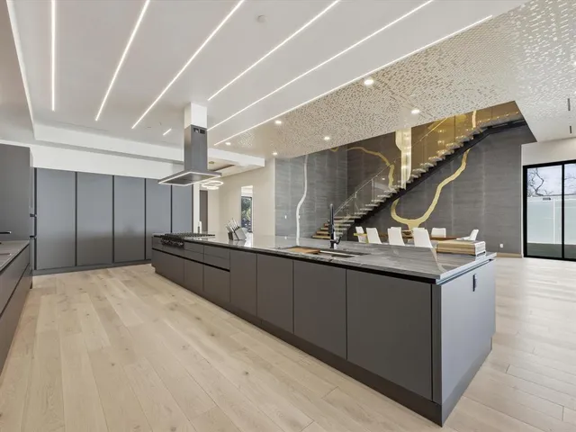 a living room with furniture a chandelier and a flat screen tv