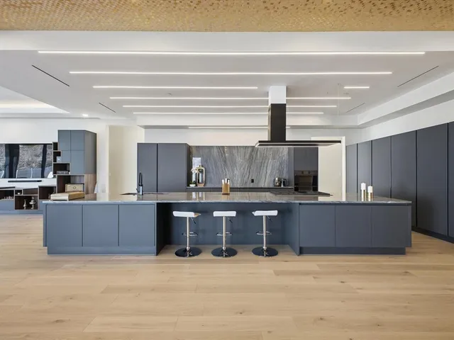 a spacious bedroom with a large bed and a large window