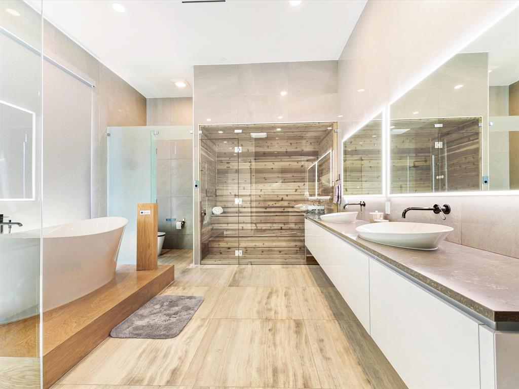 10230 Marsh Lane Dallas, TX 75229 - Photo 19 of 31 a large kitchen with kitchen island a large window a sink and stainless steel appliances