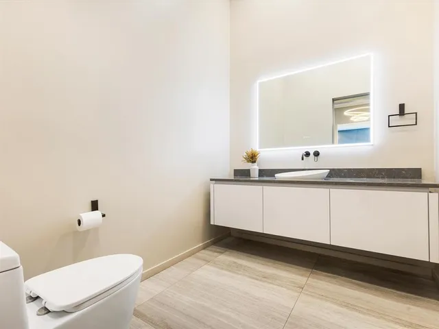 a large bed sitting in a room next to a lamp next to a window