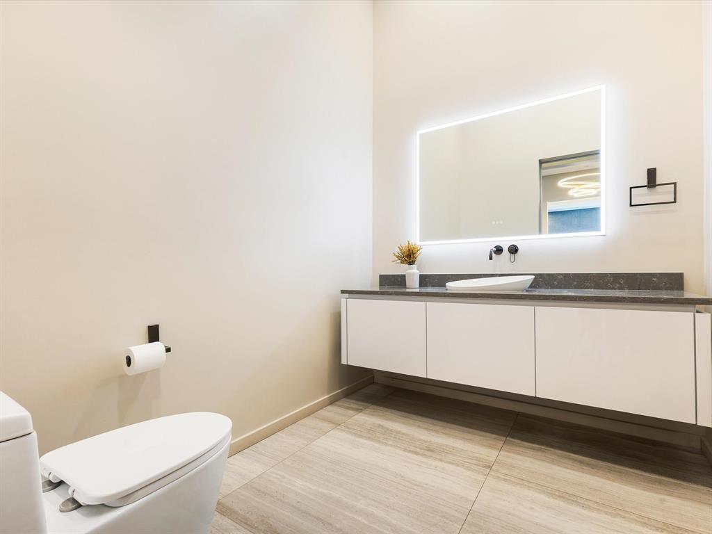 10230 Marsh Lane Dallas, TX 75229 - Photo 24 of 31 a bathroom with a granite countertop sink and a mirror
