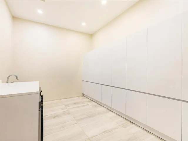 a bathroom with a double vanity sink toilet and shower