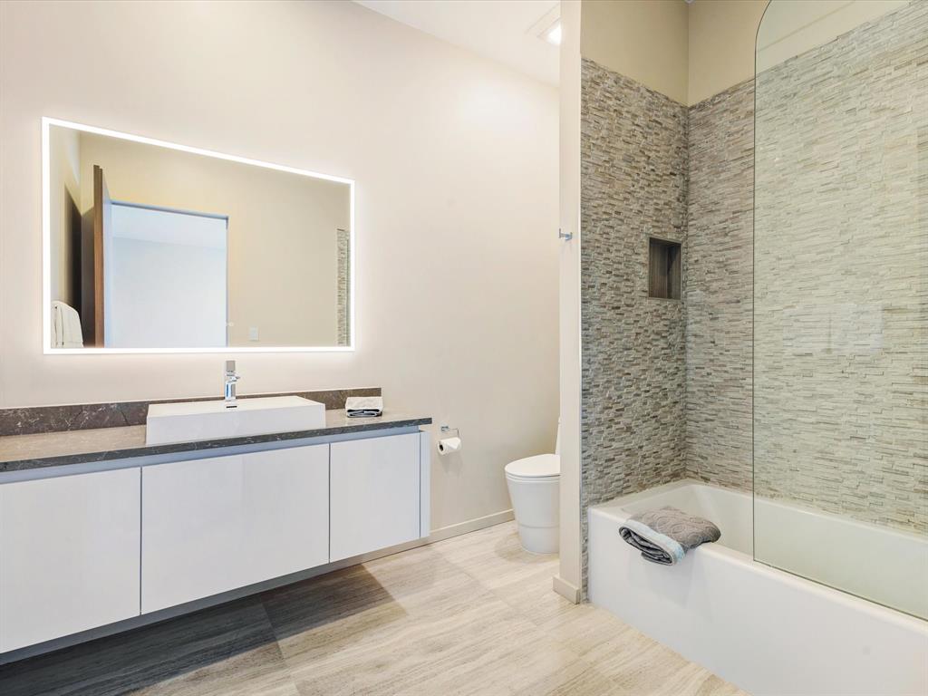 10230 Marsh Lane Dallas, TX 75229 - Photo 28 of 31 a bathroom with a double vanity sink toilet and shower