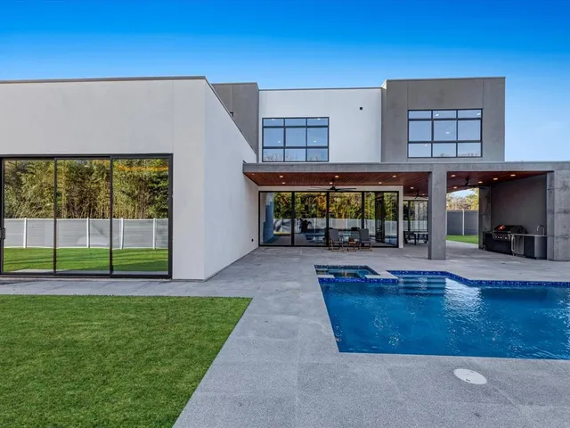 a large kitchen with stainless steel appliances a sink and cabinets