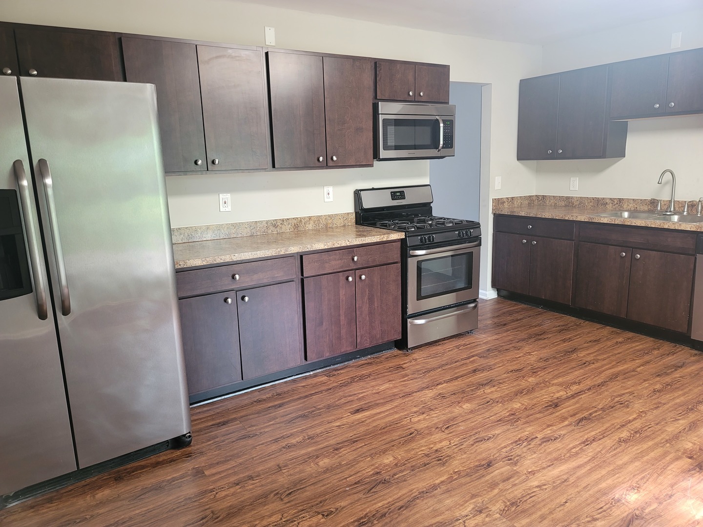 62 Springdale Road Montgomery, IL 60538 - Photo 2 of 12 a kitchen with stainless steel appliances granite countertop a refrigerator a stove a sink and a microwave oven on the wooden floor