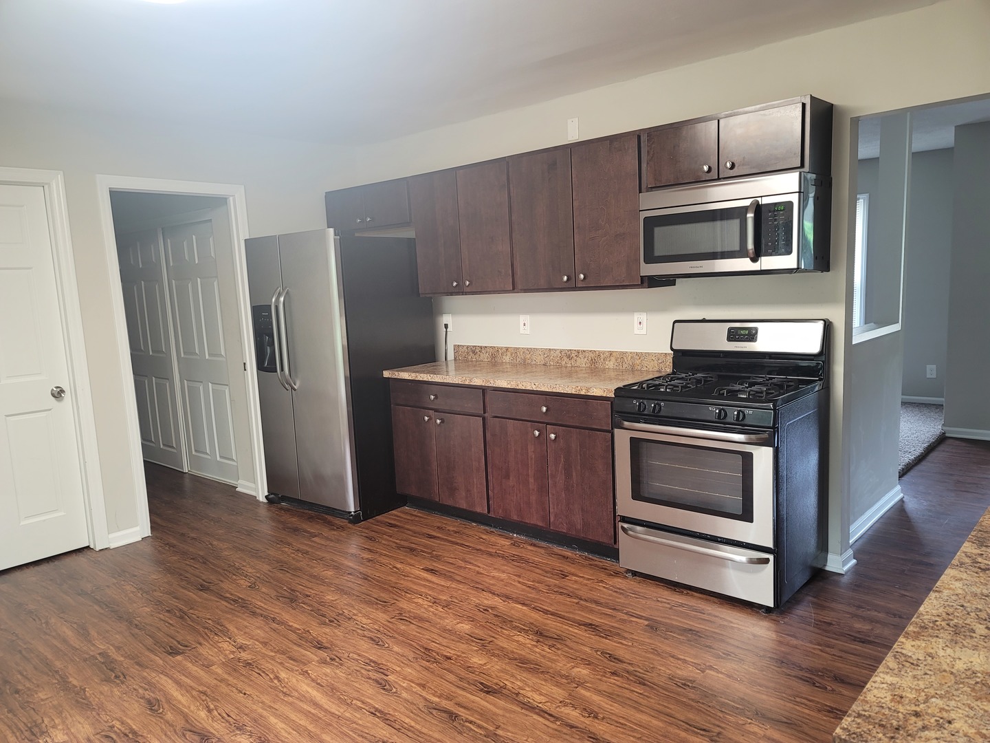 62 Springdale Road Montgomery, IL 60538 - Photo 3 of 12 a kitchen with granite countertop a stove and a microwave