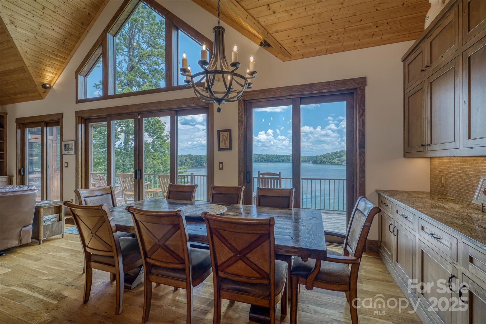 597 Waterglyn Way Nebo, NC 28761 - Photo 13 of 44 a view of a dining room with furniture large windows and wooden floor