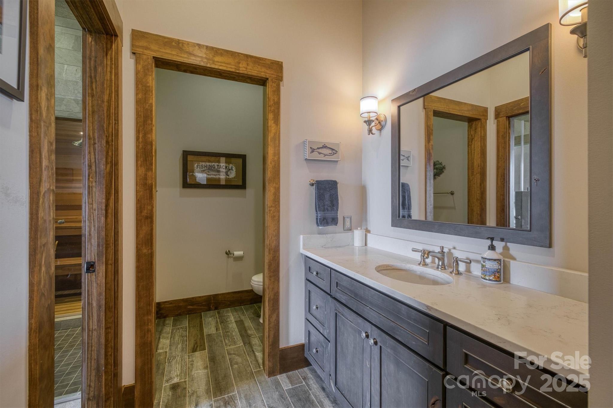 597 Waterglyn Way Nebo, NC 28761 - Photo 32 of 44 a bathroom with a granite countertop sink mirror and a shower