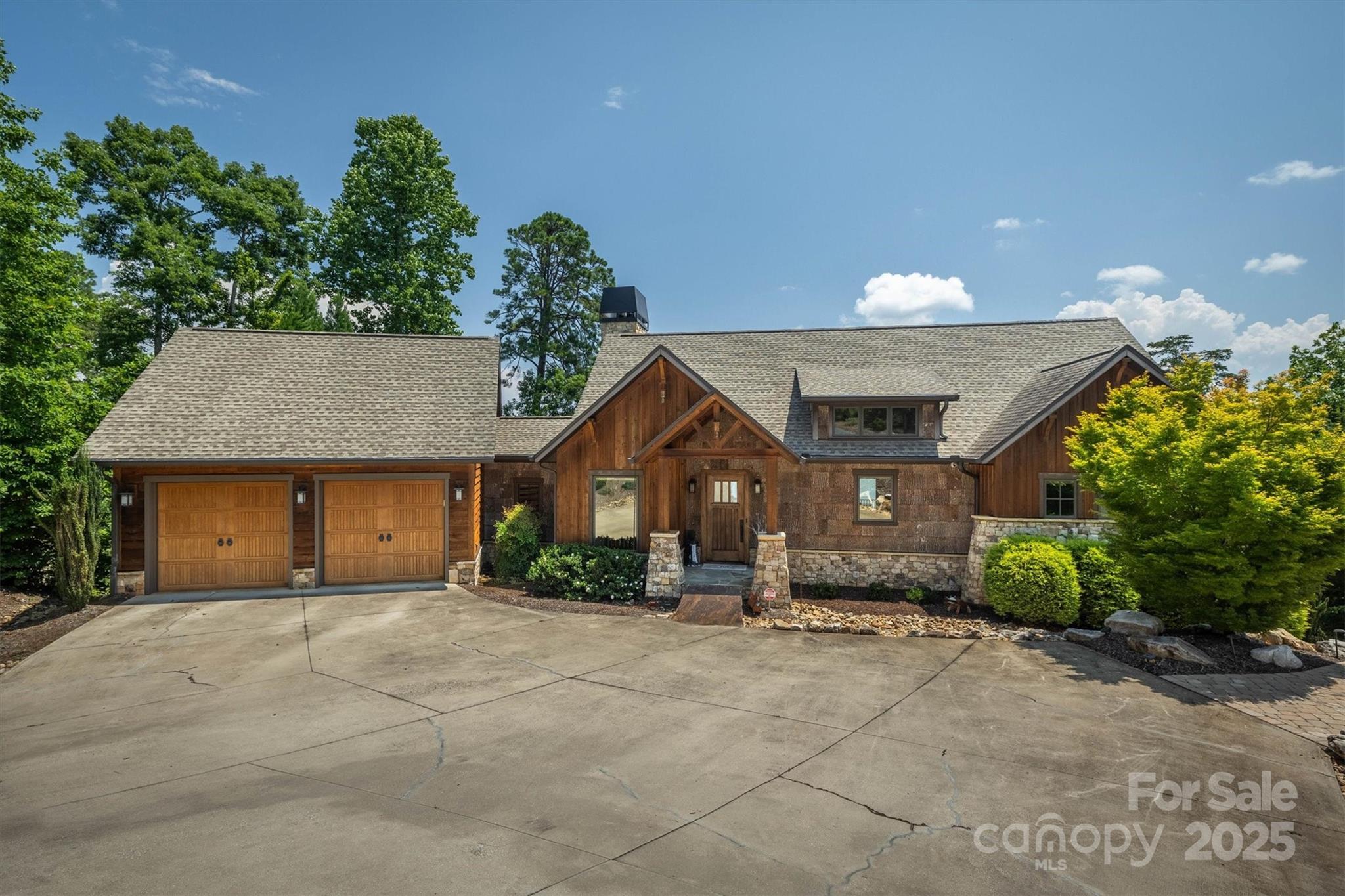 597 Waterglyn Way Nebo, NC 28761 - Photo 4 of 44 a front view of a house with a yard and a garage
